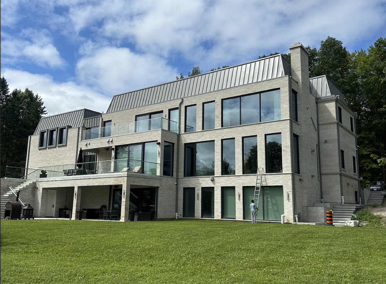 Cleaning tall windows on a modern estate