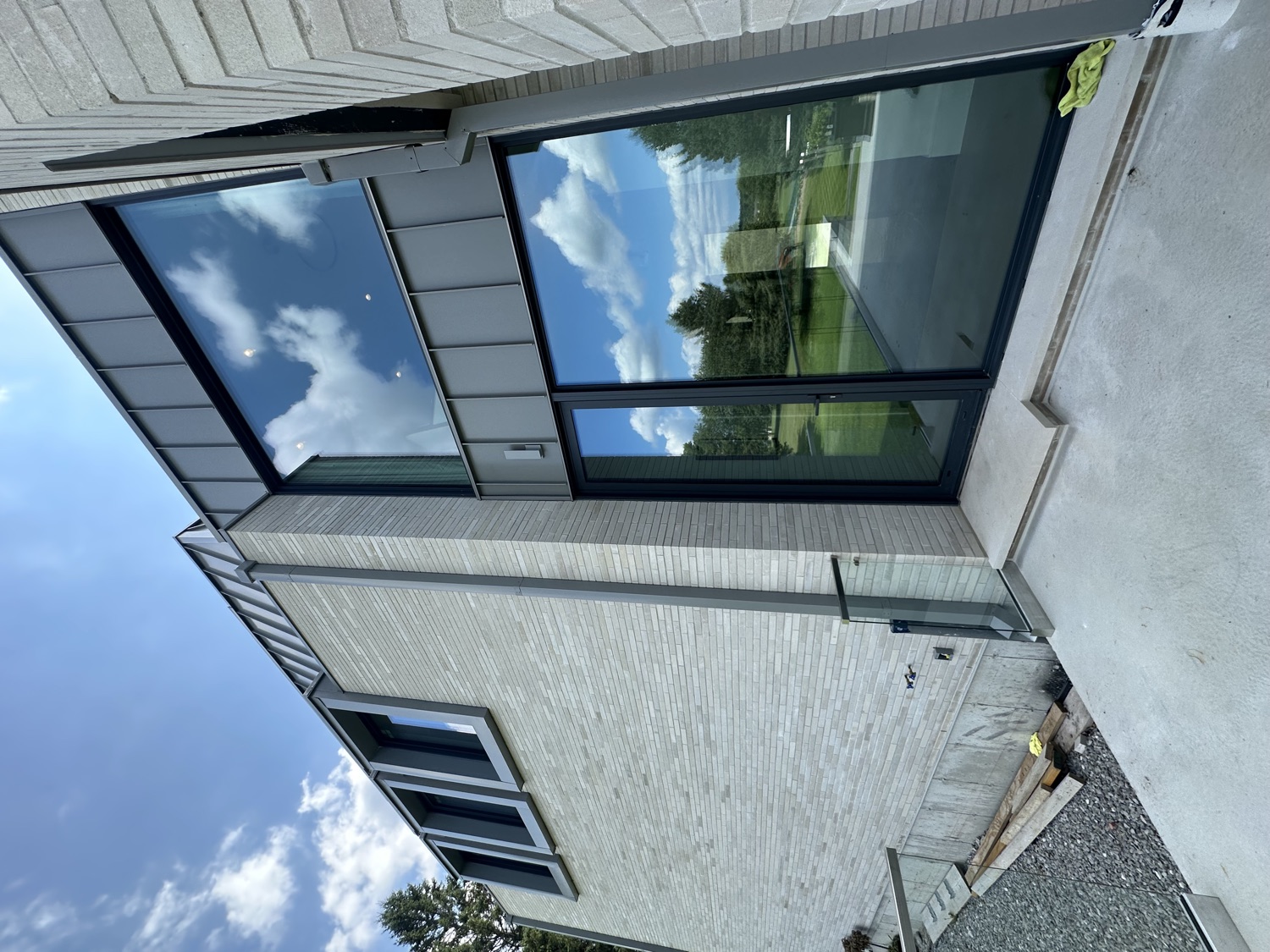 Modern glass home with sky reflections