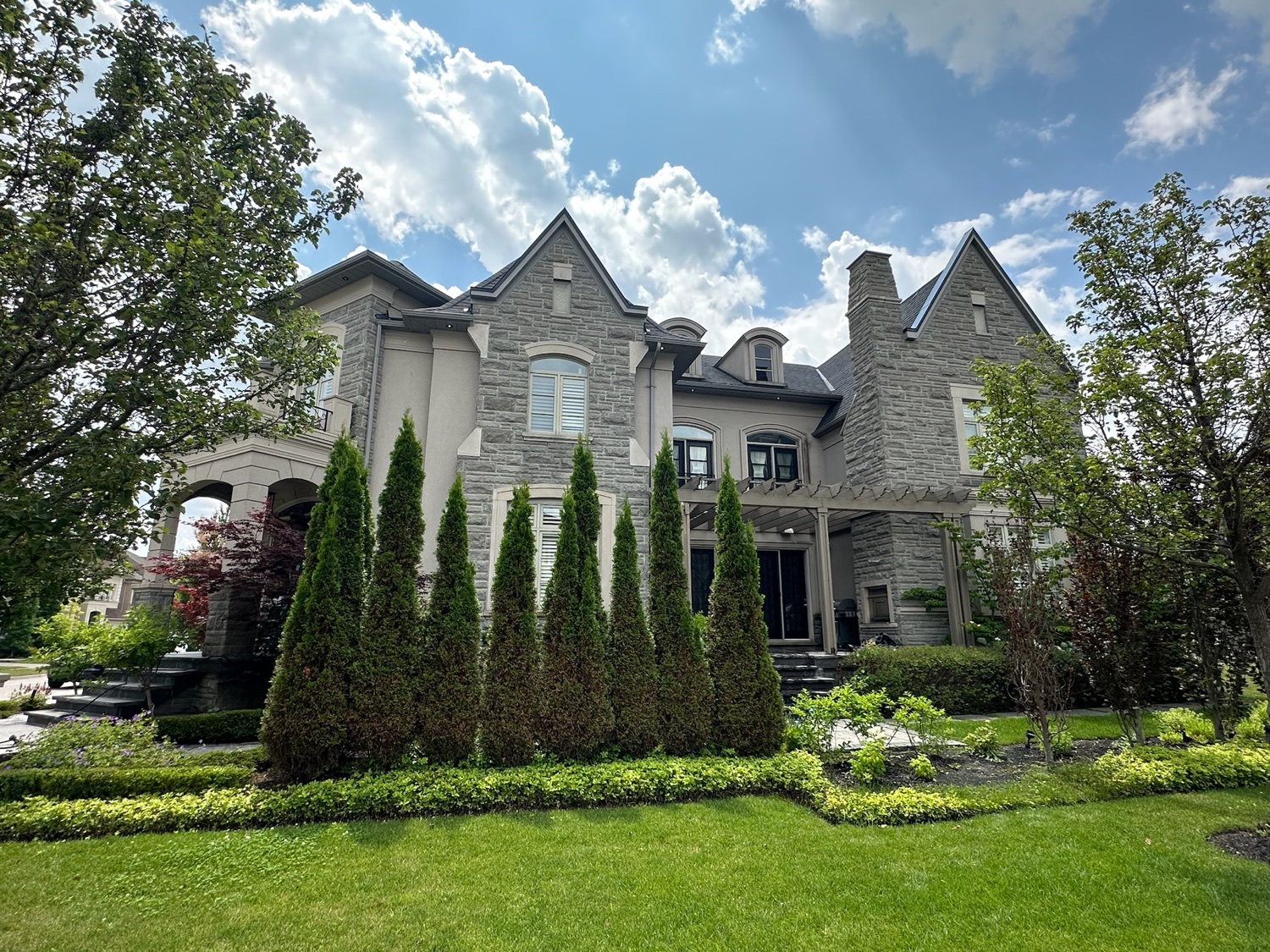 Grand stone estate with manicured grounds