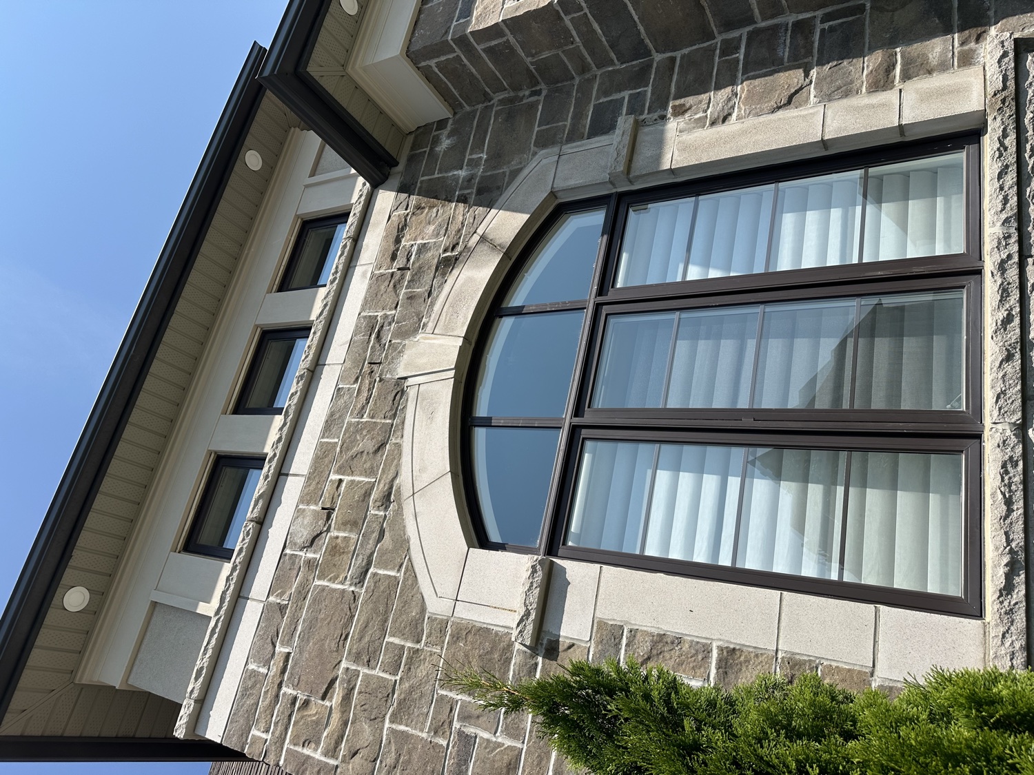 Stone home with a crystal-clear arched window