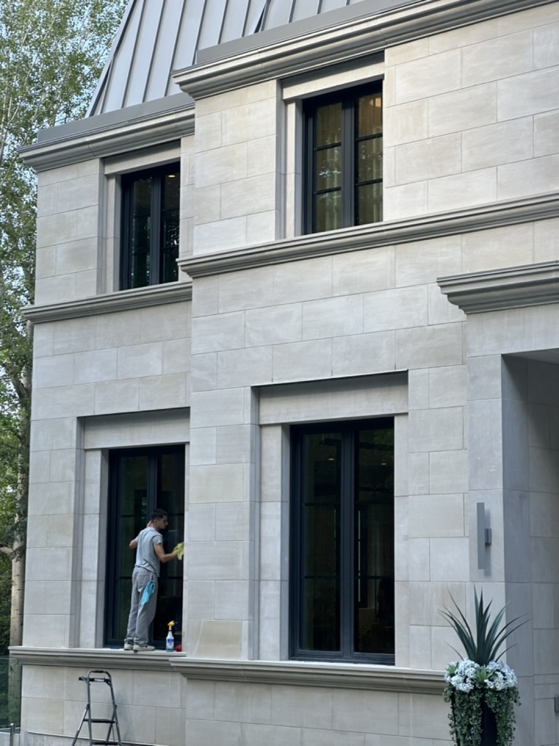 Hand-detailing a window on a limestone mansion