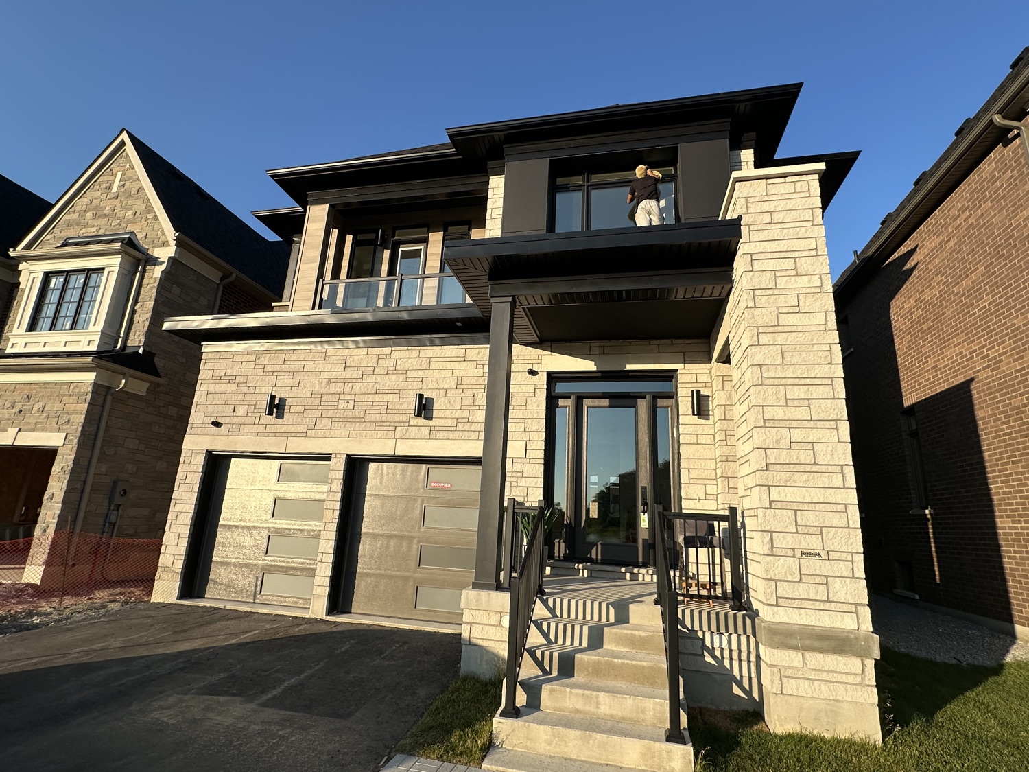 Cleaning second-storey windows on a modern home