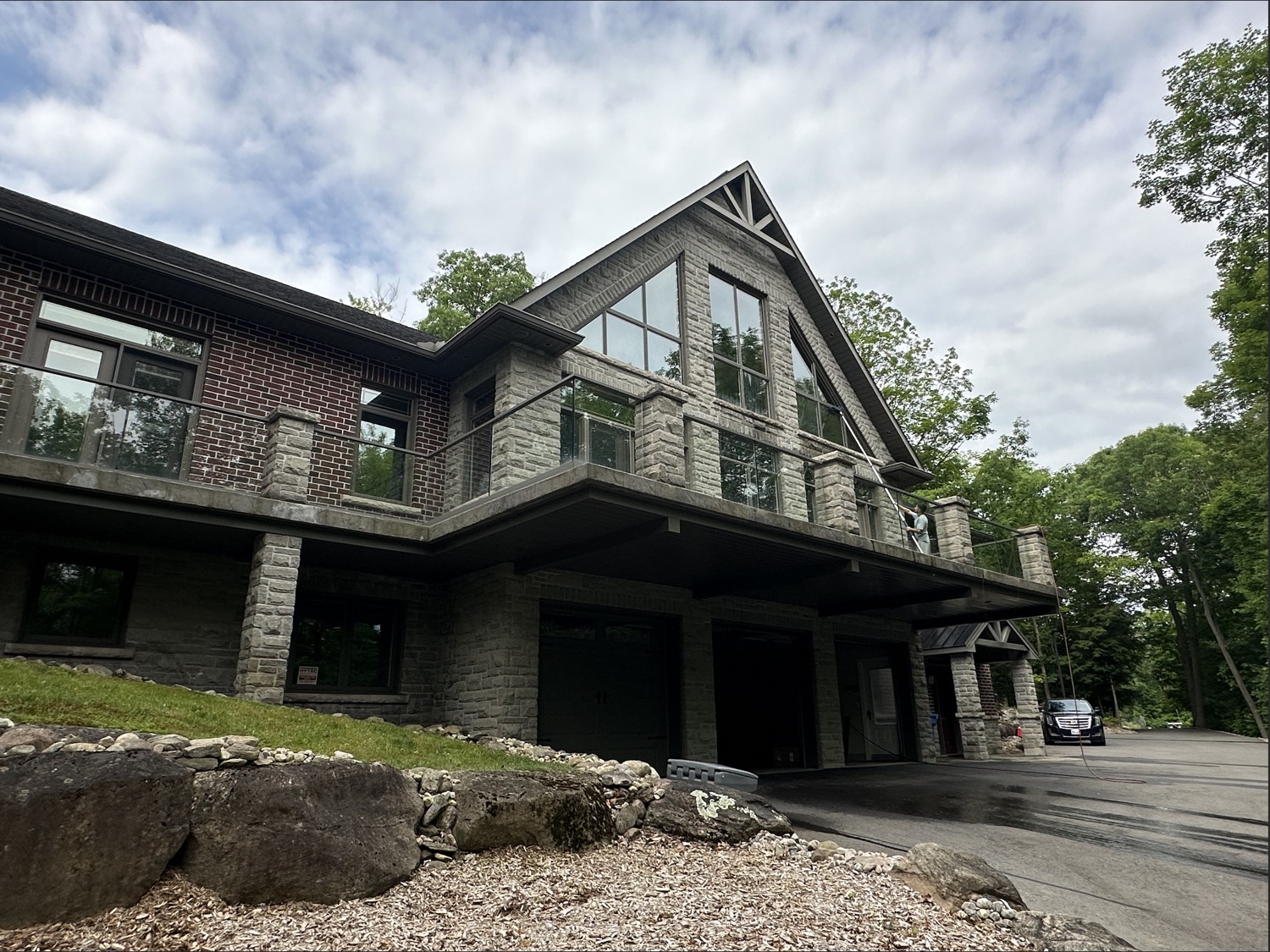 Stone home, glass railing and clean windows